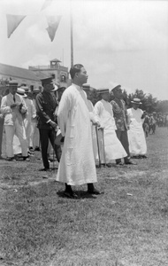 Wang Jingwei wearing a white changpao at an outdoor meeting