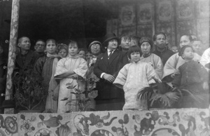 A group, including a foreigner, on a stage or rostrum