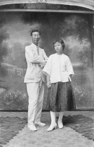 A couple, with a bucolic studio backdrop