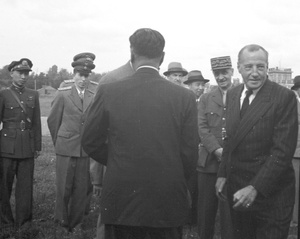 Group of military and political officials at airfield to greet T.V. Soong