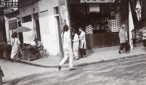 A street corner - a food cart near a shop selling soap