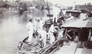 Boatmen and passengers on a houseboat