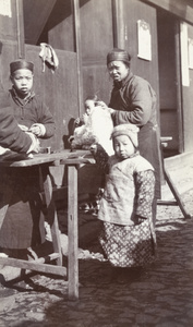 Tailors with a child in winter clothes