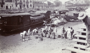 Cockle pickers gathering shell fish, and Zhejiang Road Bridge, Shanghai