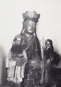 Shrine with crowned Buddha and two bearded attendants