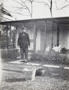 Poultryman with scraps for chickens, by the poultry house, 727 Avenue Haig, Shanghai