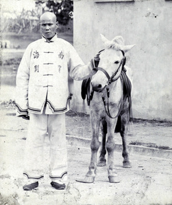 Chair-bearer and 'Pong', a pony, Nanning