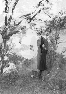 Double-exposed photograph with Gladys Hutchinson, Lilian Thoresen, and Elsie Markham in an area above a Castle Peak Road beach, Hong Kong