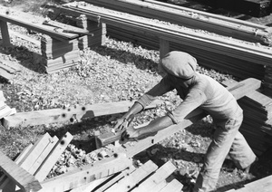 Worker planing wood for trucks, Kowloon, Hong Kong