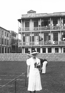 Unidentified woman modelling an outfit and hat, Hong Kong