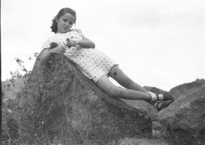 Kristine Thoresen leaning on a weathered rock, Hong Kong