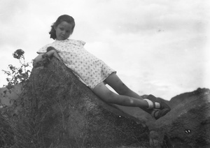 Kristine Thoresen leaning on a weathered rock, Hong Kong