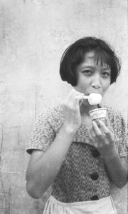 Gladys Hutchinson eating Dairy Farm ice cream, Kowloon, Hong Kong