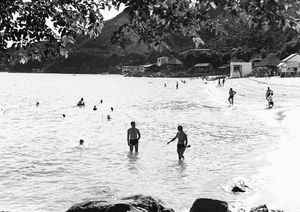 Bathers and beach huts at a Castle Peak Road beach, Hong Kong