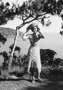 Bea Hutchinson modelling a staw hat, in an area above 12 Milestone Beach, Castle Peak Road, Hong Kong