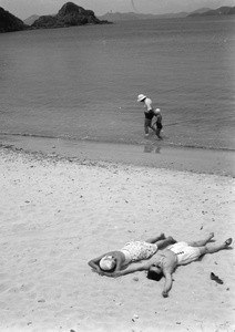 Lucy Shirazee and a friend sunbathing, South Bay Beach, Hong Kong