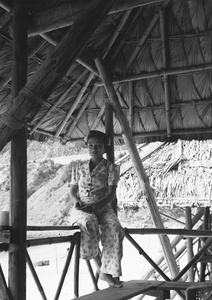 Lucy Shirazee on the balcony of a beach hut, Hong Kong