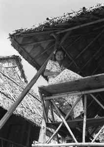 Lucy Shirazee on the balcony of a beach hut, Hong Kong