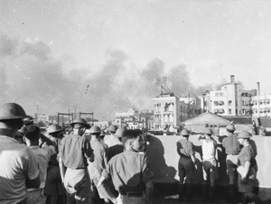 Soldiers on the roof of a building as clouds of smoke drift over Shanghai, August 1937