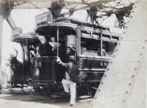 Man climbing aboard a tram-car, Shanghai