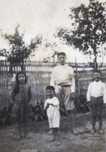 Maggie, Fred, Bill and Dick Hutchinson in the garden, 35 Tongshan Road, Hongkou, Shanghai