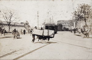 Porters, rickshaws, trams and pedestrians near Garden Bridge, Shanghai