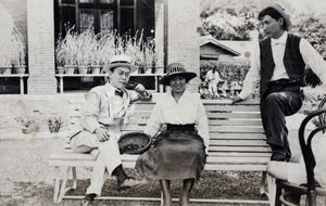 William Hutchinson standing beside a man and woman on a garden bench, 35 Tongshan Road, Hongkou, Shanghai