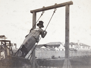 Young woman standing on a swing in the garden of 35 Tongshan Road, Hongkou Shanghai