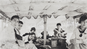 Friends around a gramophone player on an excursion boat, Shanghai