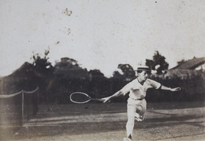 John Piry wearing a boater hat and playing tennis, Shanghai