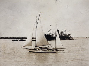 Small sail boat and large ship on the Huangpu, Shanghai