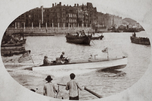 Motor boat with American flag speeding away from Suzhou Creek, Shanghai