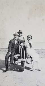 Charles Hutchinson and Gladys Gundry sitting on a wheelbarrow, Wusong, near Shanghai
