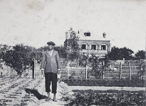 Gardener standing beside raised beds, Tongshan Road market garden, Hongkou, Shanghai