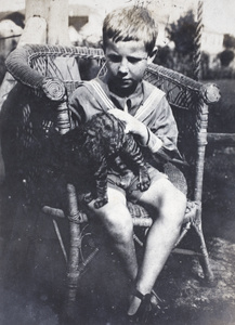 Neighbouring boy with a kitten in the garden of 35 Tongshan Road, Hongkou, Shanghai