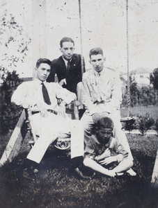 Bill Hutchinson, John Piry, John Henderson and neighbouring boy with a kitten in the garden of 35 Tongshan Road, Hongkou, Shanghai