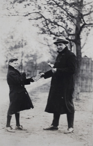 Charles Hutchinson and neighouring boy with chocolate bars, Tongshan Road, Hongkou, Shanghai