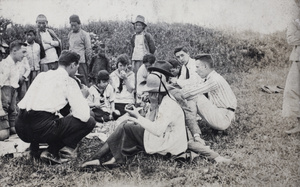 Chinese locals watching a group of friends picnicing on a day out, near Shanghai