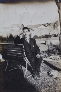 Tom Hutchinson sitting on a garden bench, 35 Tongshan Road, Hongkou, Shanghai