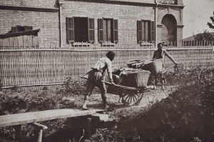 Two barrow men at a plank bridge over the ditch alongside 35 Tongshan Road, Hongkou, Shanghai