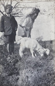 Fred Hutchinson and neighbouring girl with two-headed conjoined goat kids, Hongkou, Shanghai