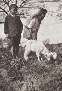 Fred Hutchinson and neighbouring girl with two-headed conjoined goat kids, Hongkou, Shanghai