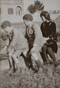 Fred, Dick and Maggie Hutchinson on a wall near 35 Tongshan Road, Hongkou, Shanghai