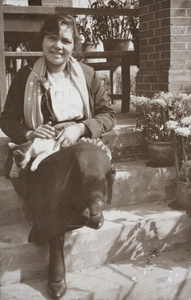 Hannah holding a cat and sitting on the verandah steps, 35 Tongshan Road, Hongkou, Shanghai