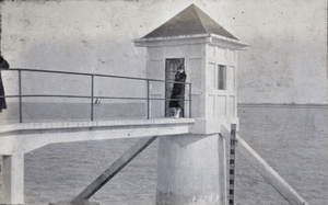 Young woman on the footbridge to a tide house, Wusong, February 1920