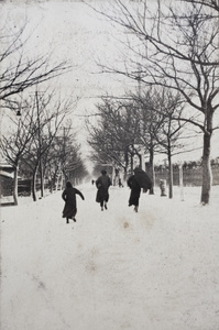 Three people running along snow covered Tongshan Road, Hongkou, Shanghai, February 1919