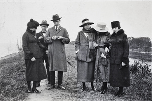 John Piry and Bill Hutchinson whittling sticks while on a day out with four women, Shanghai