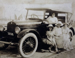 Mrs Hansen at the wheel of Charles Hutchinson's automobile with Miss Hansen, Sarah and Margie Hutchinson sitting on the dashboard