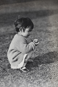 Bea Hutchinson eating a peach in the garden, 35 Tongshan Road, Hongkou, Shanghai