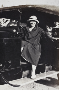 Margie Hutchinson posing at the wheel of an automobile, Wusong, September 1923